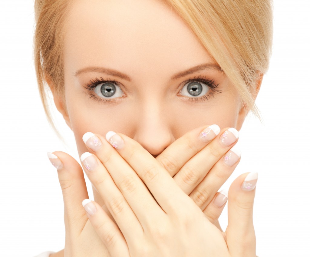 amazed woman with hand over mouth
