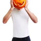 Halloween pumpkin on man head, joking, clipping path