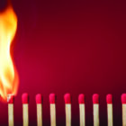 Burning match setting fire to its neighbors