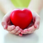 close up of child hands holding red heart